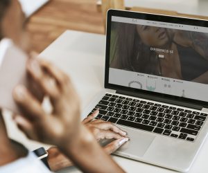 Woman making a phone call while working on her laptop